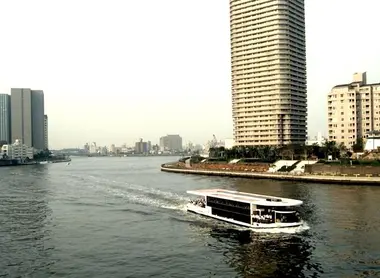 A barge Yakatabune between the buildings of Tokyo Bay.