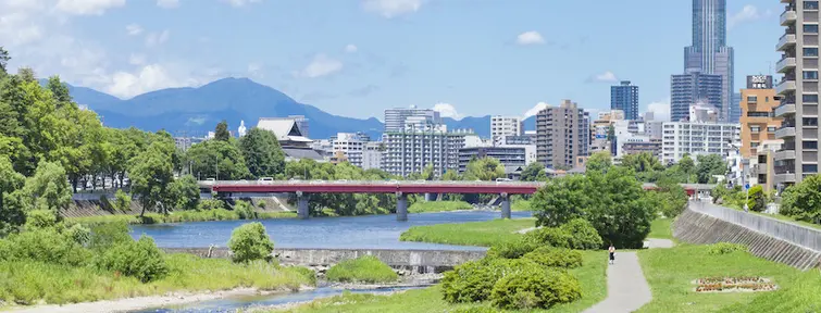 Hozu River with the city on the right and hills in the background